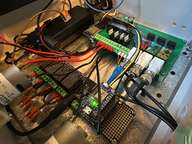 a computer board with wires and a small device